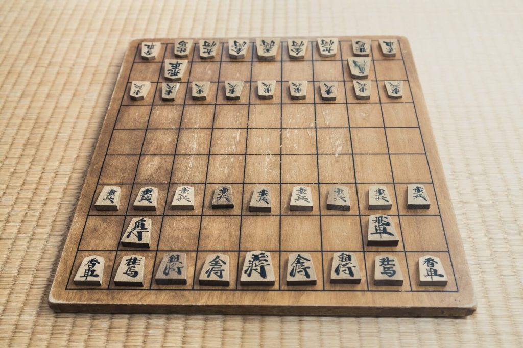 【Fig1 Peices and a board of shogi】